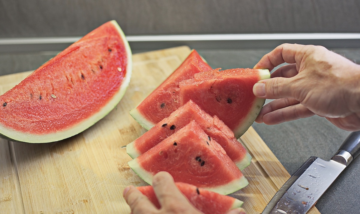 Cutting up watermelon in the summer. Image: Pexels - Damir Mijailovic