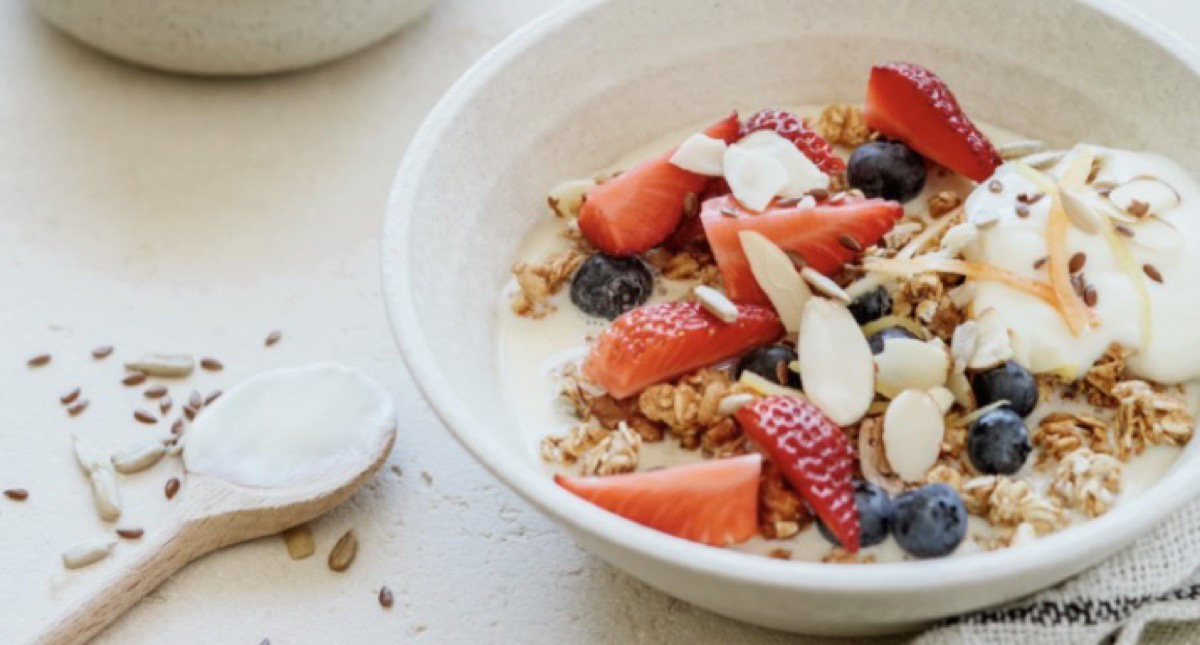 A bowl of yogurt with fruits and granola